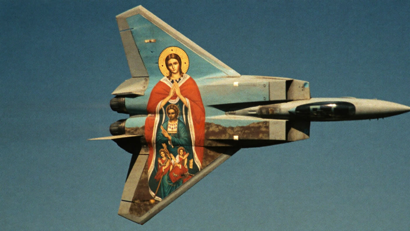 The underside of a fighter jet with a Byzantine icon painted across it