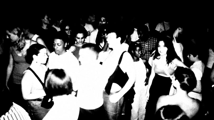 A crowd lit by flash