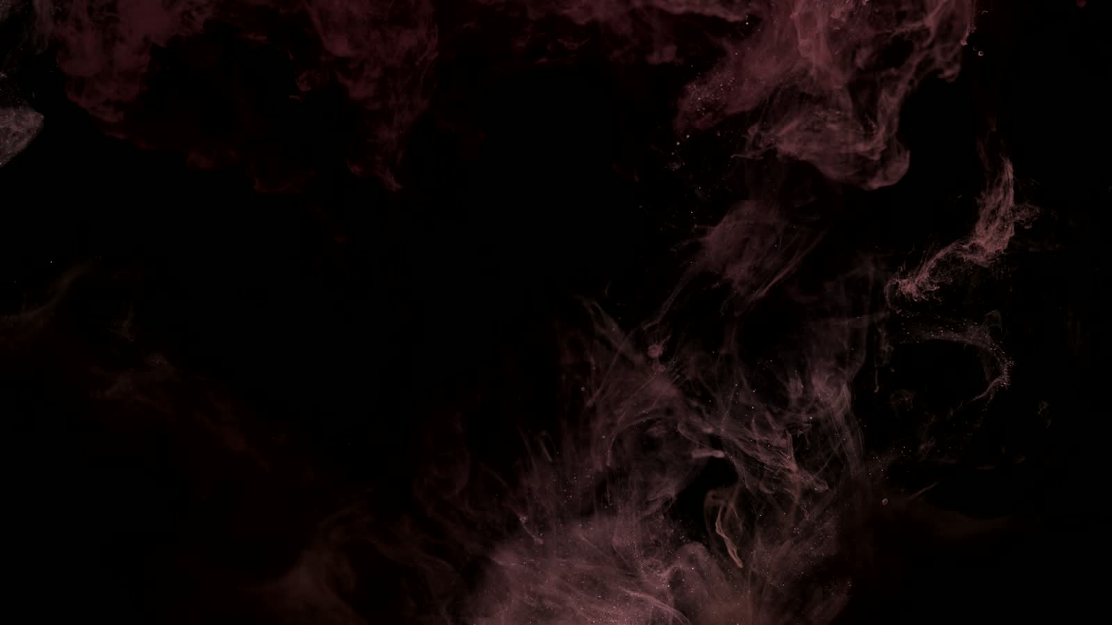 Red smoke suspended in dark liquid