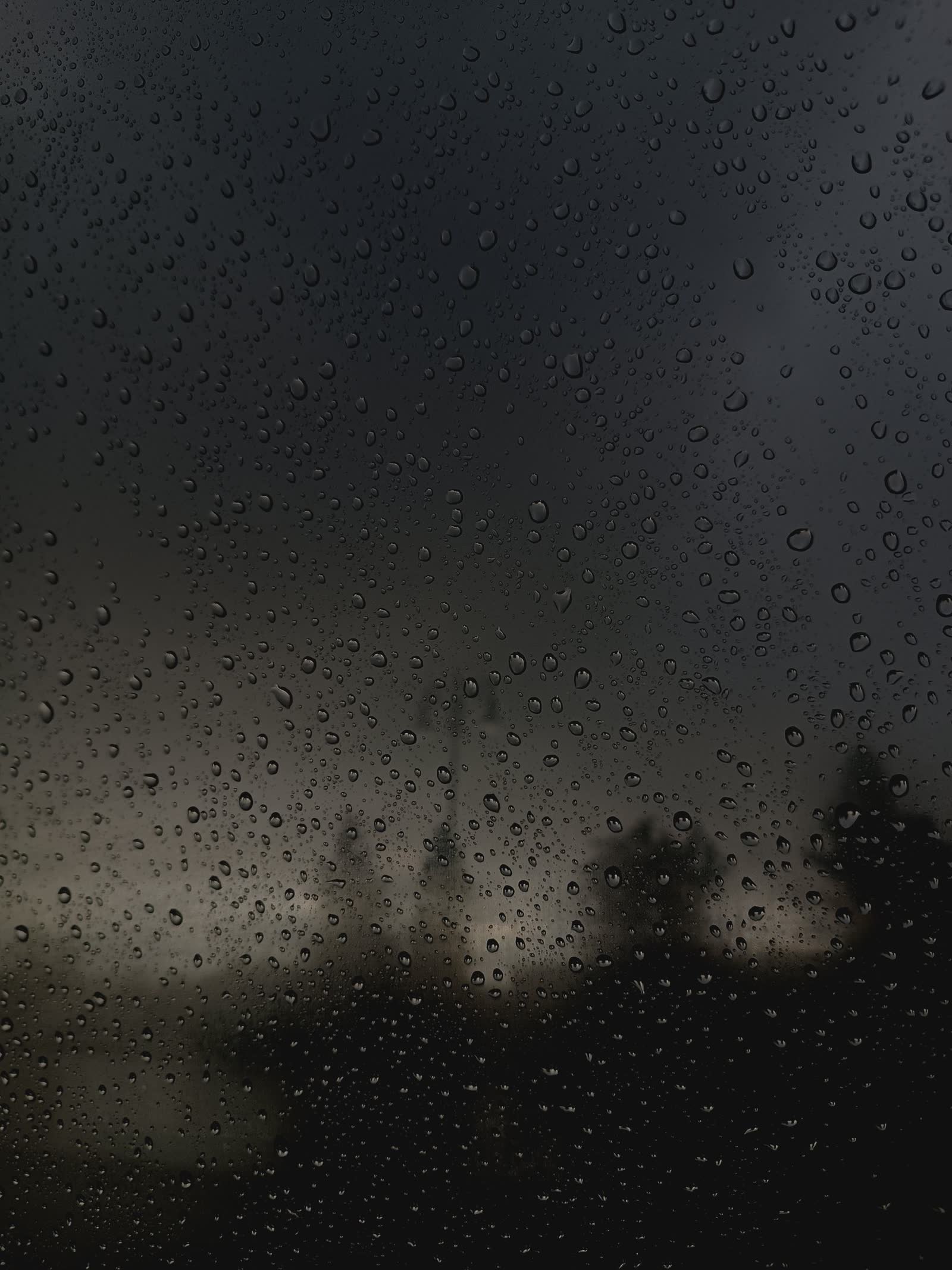 Rain on dark glass at night